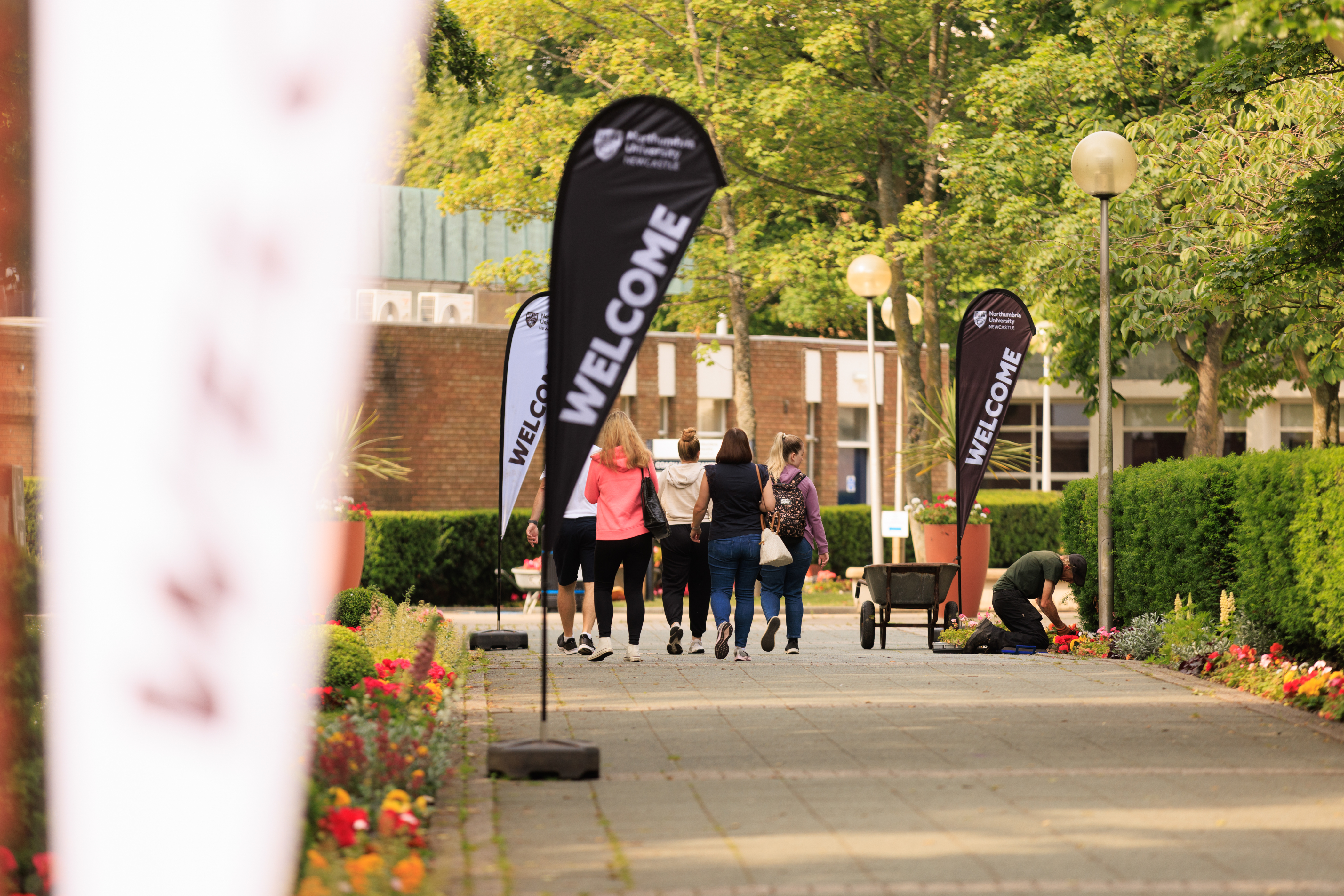 Students on campus with welcome signs