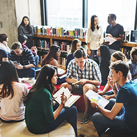 a group of students reading and talking