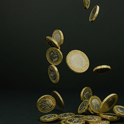concept image of pound coins falling into a small pile