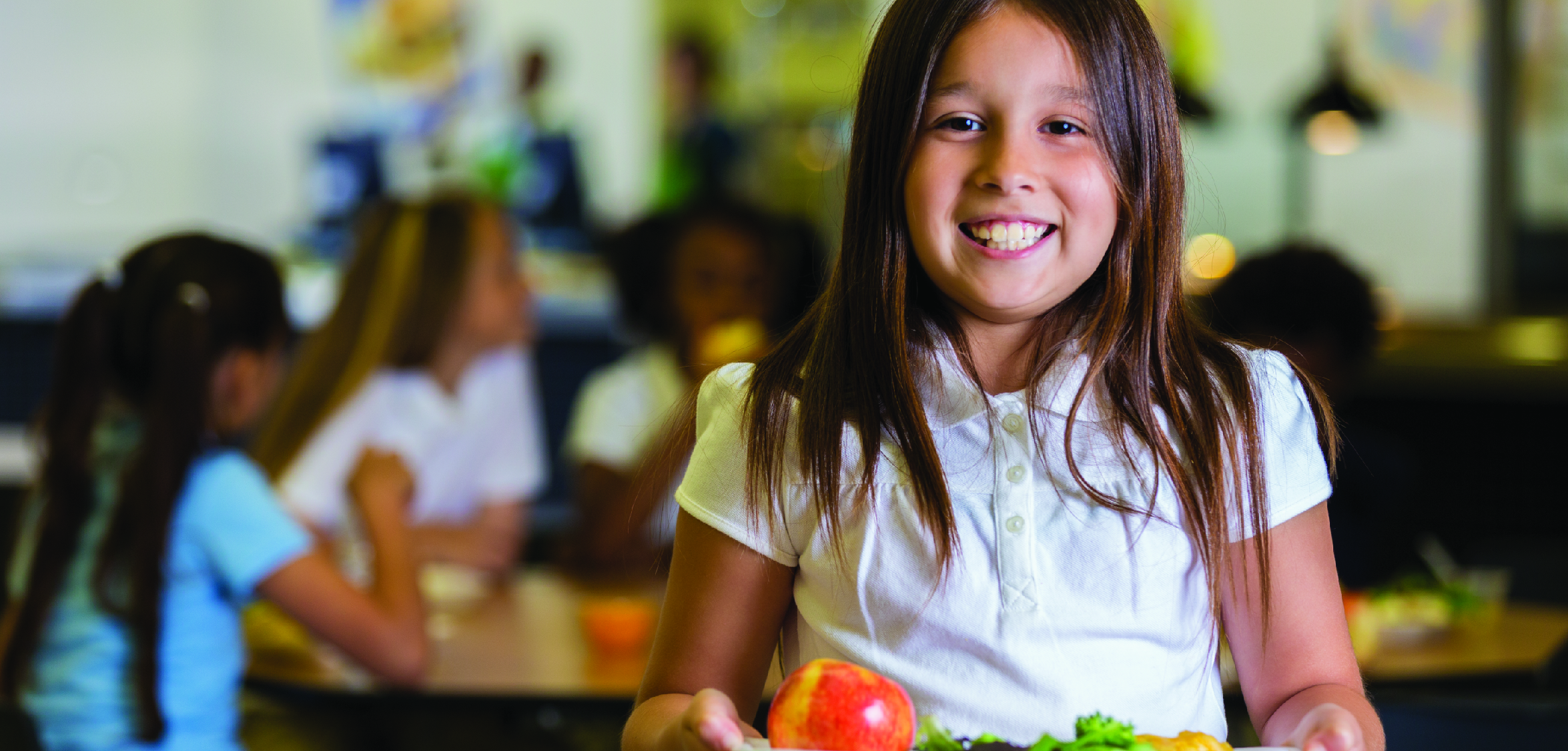 School child smiling with plate of food