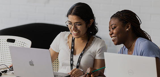 two students working on laptop
