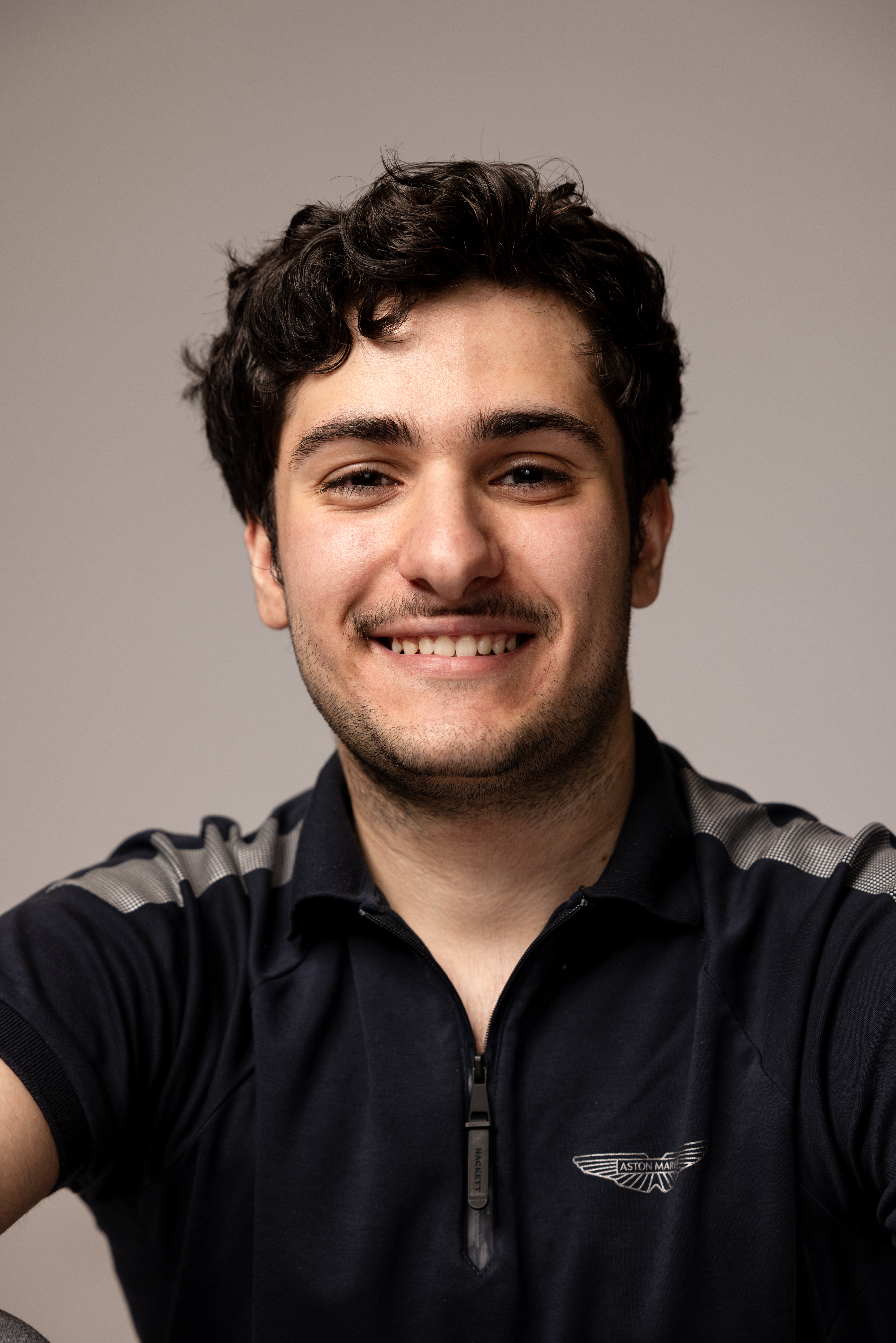 Man smiling at the camera wearing a black t-shirt