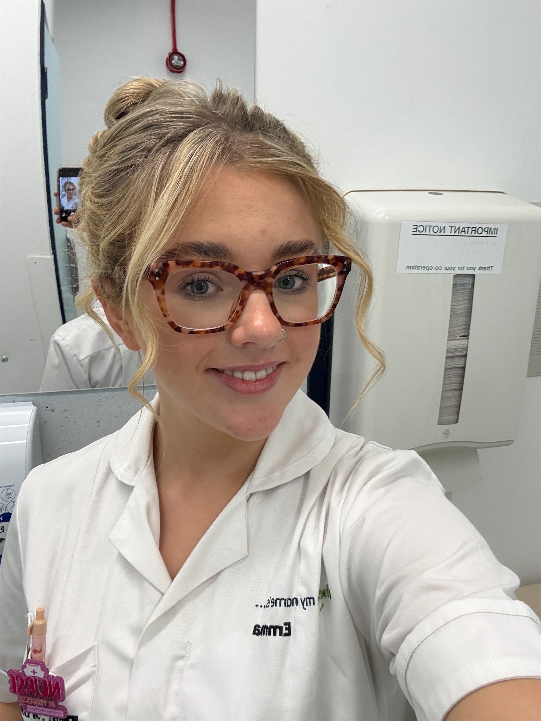 Selfie of a female student wearing a nurse uniform, smiling at the camera