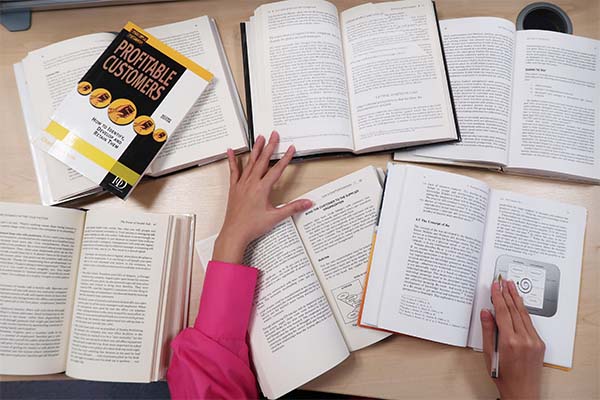 A student studying and reading books.