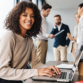 woman working on laptop smiling