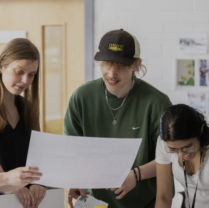 students looking at a piece of paper