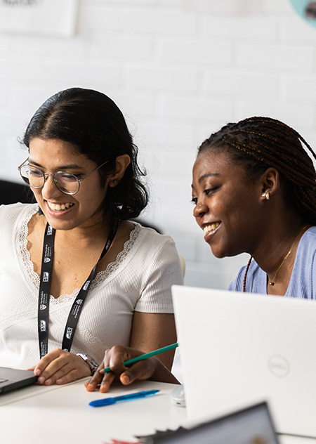 two students looking at laptop