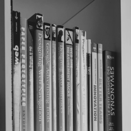 Black and white image of books on a shelf