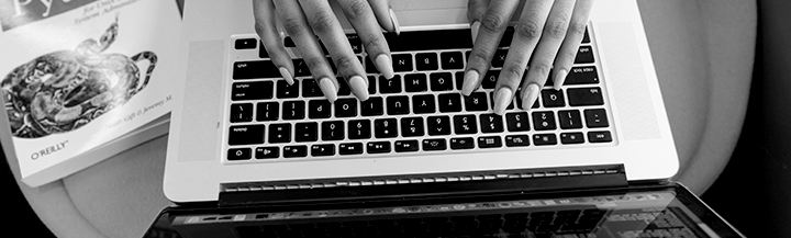 Hands on a laptop keyboard