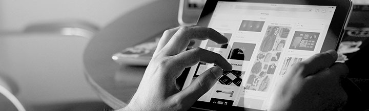 A hand uses a tablet screen