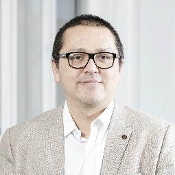 a man wearing glasses posing for the camera