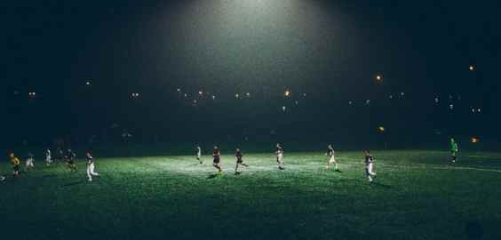 football match at night with flood lights on