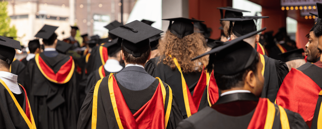 view of students wearing graduation cap and gown