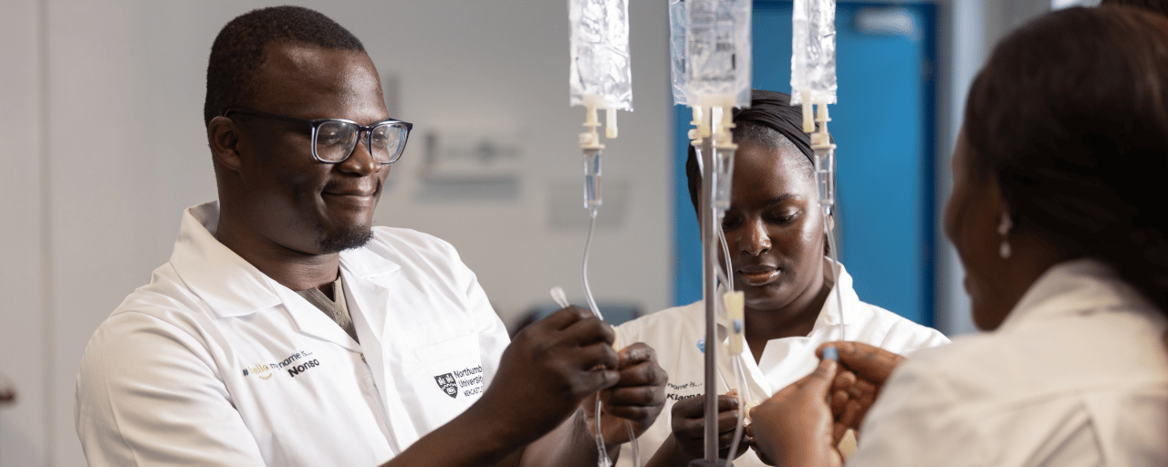 Students working together using nursing equipment