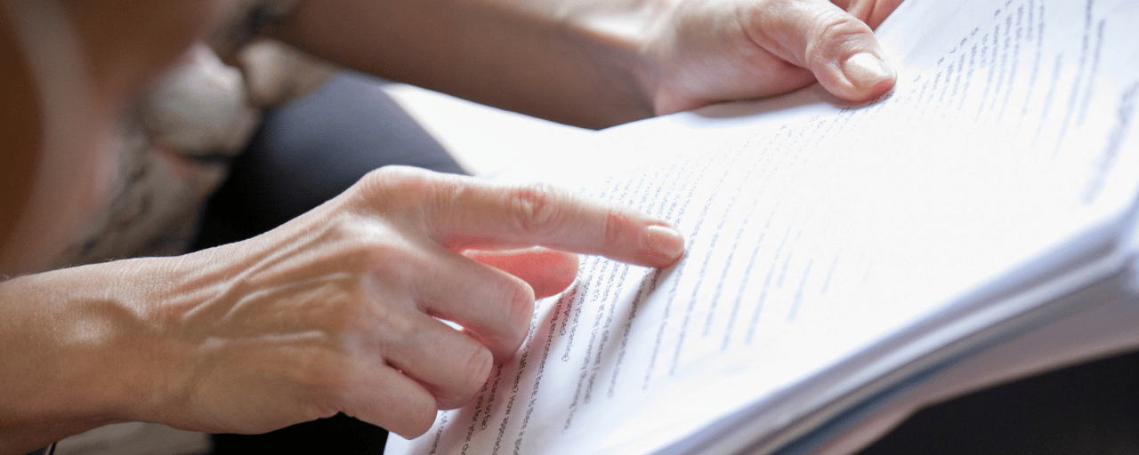 woman pointing to words on a page
