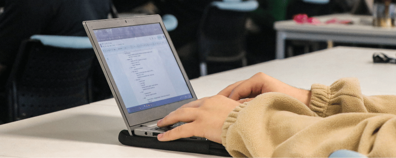 Close up of student typing on a keyboard