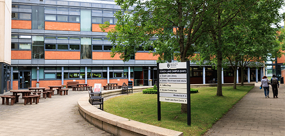 Exterior of Coach Lane Campus including benches and trees