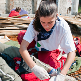 Women volunteer at disaster scene preparing supplies
