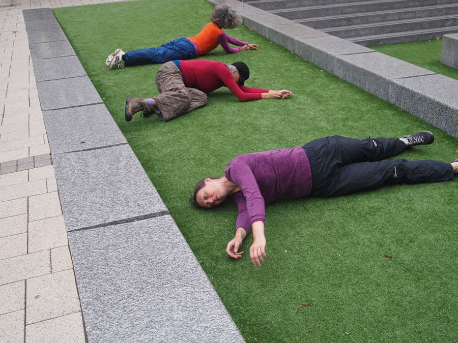 a person lying on a sidewalk
