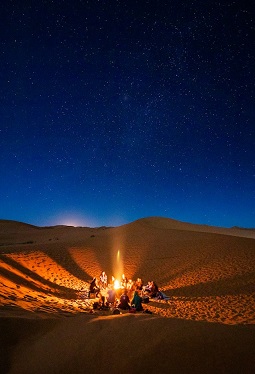 People around a fire in the desert