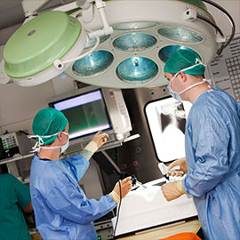 two healthcare professionals overlooking a monitor