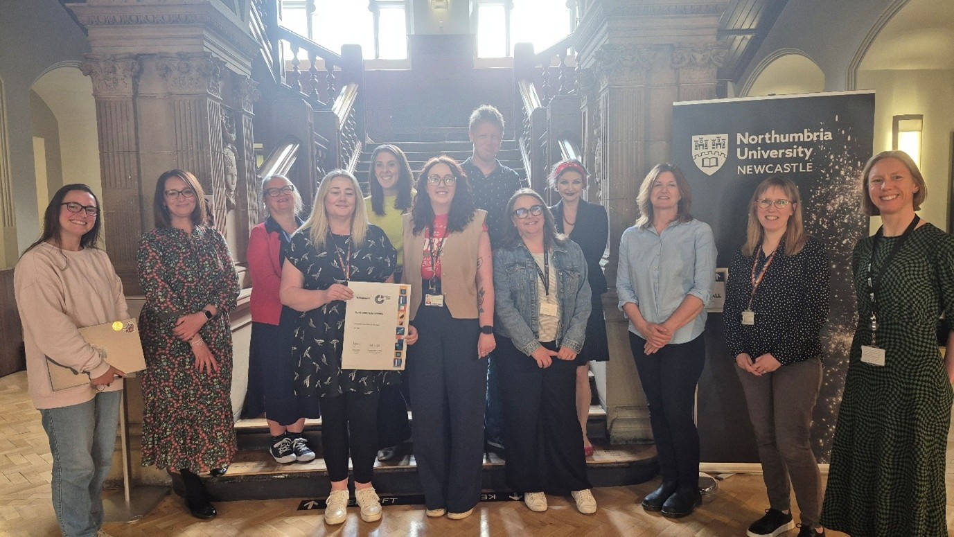Photograph of members of the Gender Equality Steering Group who were involved in the Athena Swan Silver submission, with Rachel Brown, Director of EDI, holding the award certificate.