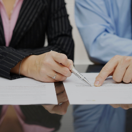 Close up of hands pointing at a document