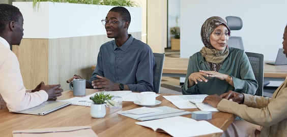 Two women and two men talking at the office,