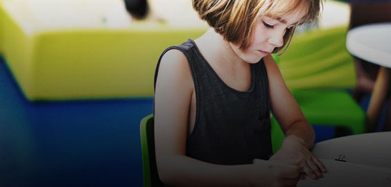 a woman sitting at a table using a laptop