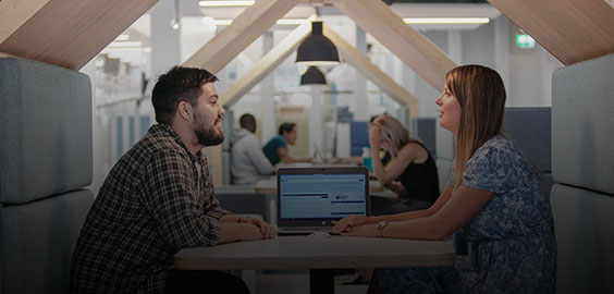 a group of people looking at a computer