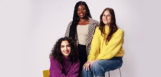 3 students sat in a studio settings at different heights