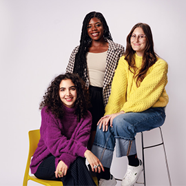 3 students sat in a studio settings at different heights