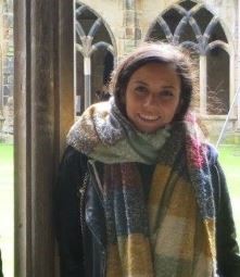 a woman standing in front of a window
