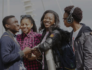 Nigerian students laughing together on the Northumbria University bridge