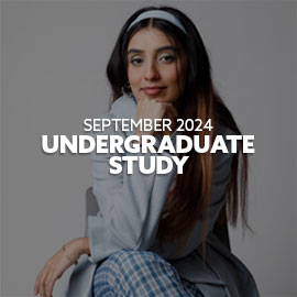 Close-up of a female Pakistani student sat in a chair. She is wearing a blue coat, is smiling and resting her head on her fist. There is text embedded on the image and it reads: "September 2024 Undergraduate Study"