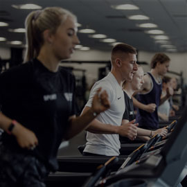Male and females students running on treadmills within Northumbria Sport Central