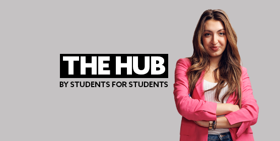 Close-up of a female student wearing a pink suit jacket, smirking at the camera. There is text embedded on the image that reads: "The Hub - by students, for students"