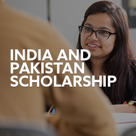 Student studying at desk. Text embedded reads: India and Pakistan Scholarship