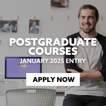 A male student is sat on the edge of a table in a design studio. There is text embedded on the image that reads: "Apply for a Postgraduate Course this January"