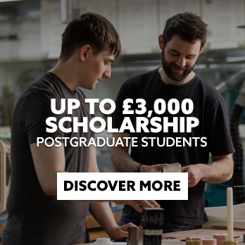Two students in a workshop with text embedded reading: Up to £3,000 Scholarship. Postgraduate Students. With CTA: Discover More.