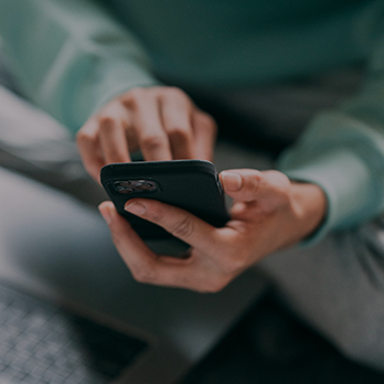 Close-up on an individual using their cellphone