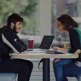 Two people sat a study table together