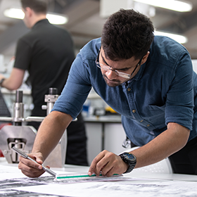 Close-up of a project management student engaging in experiential learning.