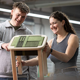 Two Design students reviewing their woodshop outputs.