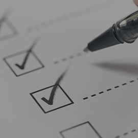 Close-up of a checking off tasks as complete with a biro pen.