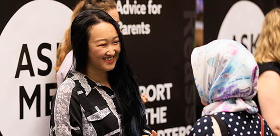 Member of staff talking to a student at an Open Day.