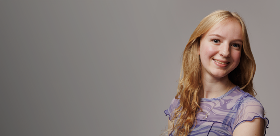 Image of a female student with blonde hair and smiling, against a white background as part of the 'I Am Northumbria' campaign.