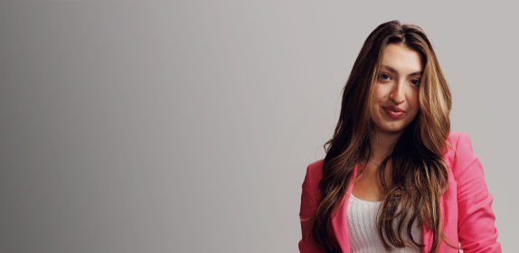 Image of a female student wearing a pink blazer, against a white background as part of the 'I Am Northumbria' campaign.