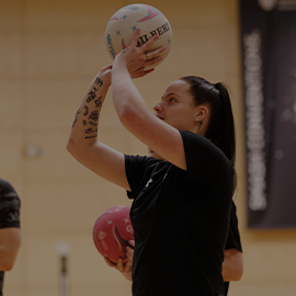 Female student playing basketball
