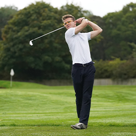student playing golf